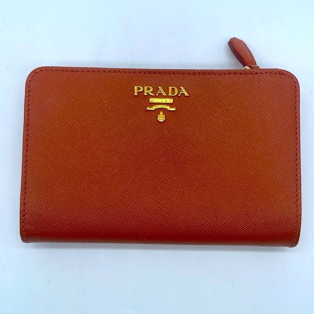 Prada Papaya Orange/ cognac Saffiano leather logo embossed bifold wallet